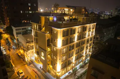 a building with a clock on top of it at night at Daraya Boutique Hotel in Bangkok