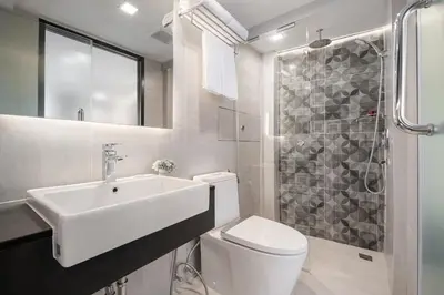 a bathroom with a sink and a toilet and a shower at Aspira Gems Center Silom in Bangkok