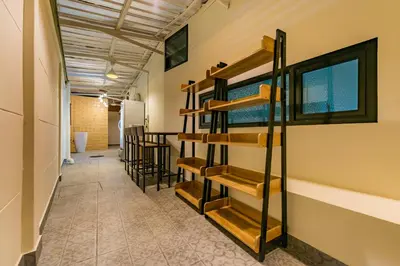 a hallway with wooden shelves on the wall at P18 Hotel Bangkok in Bangkok
