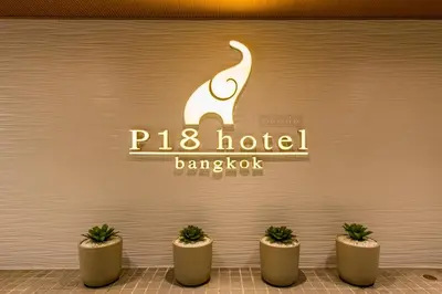 a sign for a hotel bangkok with five potted plants at P18 Hotel Bangkok in Bangkok