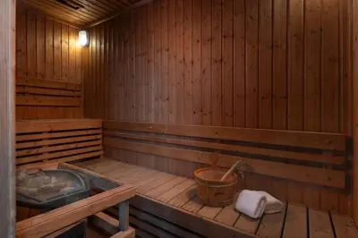 a wooden sauna with a tub and a bucket at Lumen Bangkok Srinakarin in Bangkok