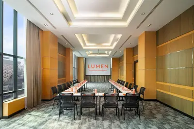 a conference room with a long table and chairs at Lumen Bangkok Srinakarin in Bangkok