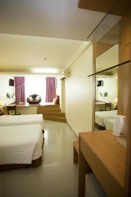 a hotel room with two beds and a window at P2 Boutique in Bangkok