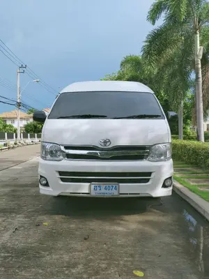 a white van parked on the side of a street at IMPACT Don Mueang Bangkok Guest House in Nonthaburi
