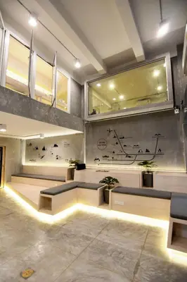 a lobby with couches and potted plants at Siam Eco Hostel in Bangkok