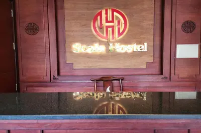 a sign for a sushi restaurant with a sign for at Scala Hostel in Bangkok