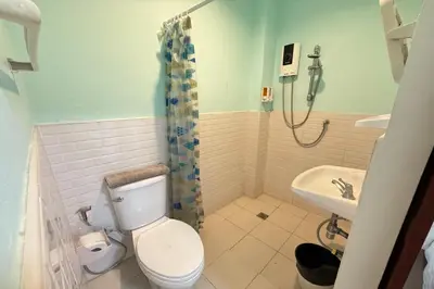 a bathroom with a toilet and a sink at Scala Hostel in Bangkok