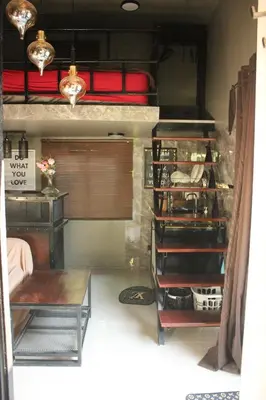 a room with two bunk beds and a table at Do Dee cafe in Bangkok