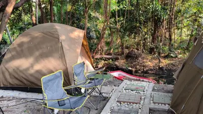 two chairs and a tent in the woods at Do Dee cafe in Bangkok