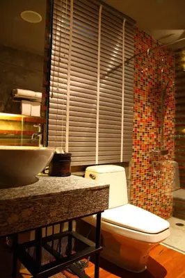 a bathroom with a toilet and a sink at The Fusion Suites in Bangkok