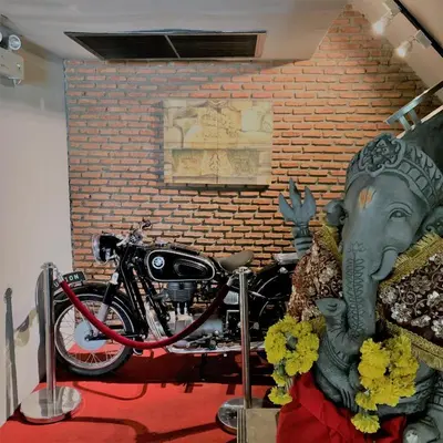 a motorcycle parked in front of a brick wall at The Fusion Suites in Bangkok