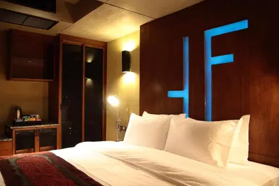 a bedroom with a bed with a blue sign on it at The Fusion Suites in Bangkok
