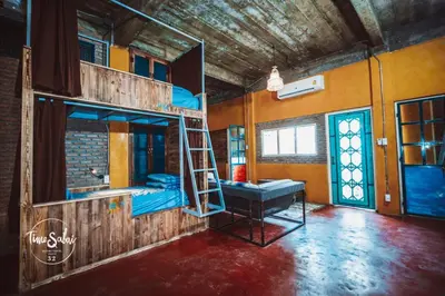 a room with two bunk beds and a ladder at Time Sabai 32 in Bangkok