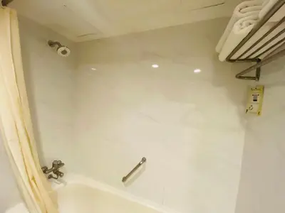 a bathroom with a tub and a sink and a shower at Gold Orchid Bangkok Hotel in Bangkok