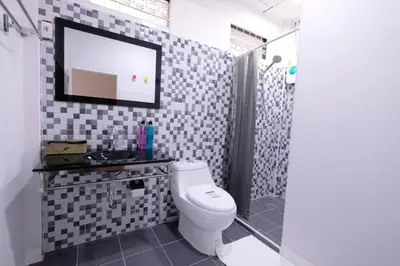 a bathroom with a toilet and a shower at 138 White Villa in Bangkok