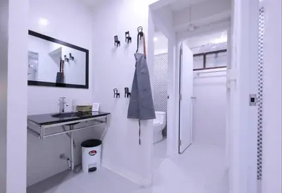 a white bathroom with a sink and a shower at 138 White Villa in Bangkok