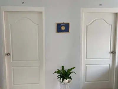 a room with two doors and a potted plant at TEAK VILLA in Bangna