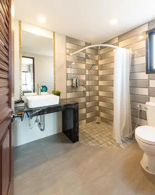 a bathroom with a sink and a shower at Tepbunthom Hostel in Bangkok