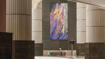 a bathroom with a large painting on the wall at InterContinental Bangkok by IHG in Bangkok