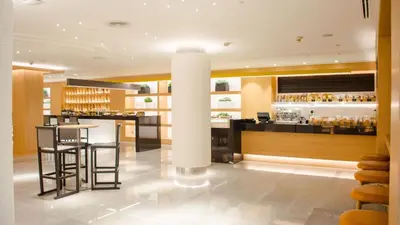 a bar in a restaurant with a white pillar at Holiday Inn Bangkok by IHG in Bangkok
