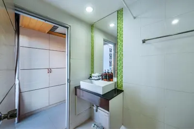 a bathroom with a sink and a shower at The Legacy Convention Hotel in Nonthaburi