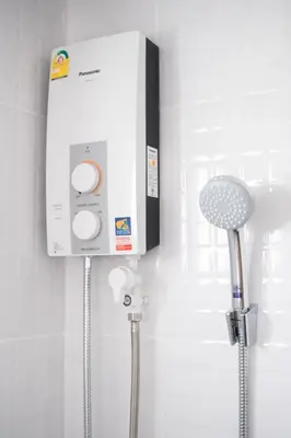 a bathroom with a shower with a control box on the wall at Oblique Apartment - ออฟบลิค อพาร์ทเมนท์ in Nonthaburi