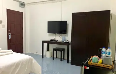 a bedroom with a bed and a desk with a television at Oblique Apartment - ออฟบลิค อพาร์ทเมนท์ in Nonthaburi