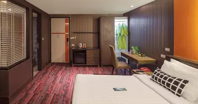 a hotel room with a bed and a desk at Tango Vibrant Living Hotel - SHA Extra Plus in Bangkok