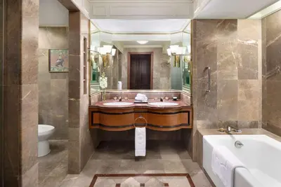 a bathroom with two sinks and a tub and a toilet at Shangri-La Bangkok in Bangkok
