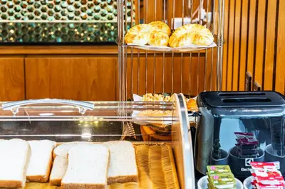 a bakery with bread and pastries on a shelf at The Grand Sala Thai in Bangkok