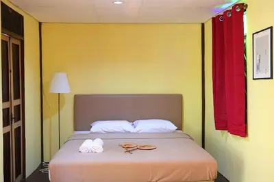 a bedroom with a bed with two pairs of sandals on it at Baankhon Private room in Thai house Check in by yourself code inbox Adult Only in Bangkok
