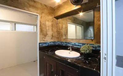 a bathroom with a sink and a mirror at Baankhon Private room in Thai house Check in by yourself code inbox Adult Only in Bangkok