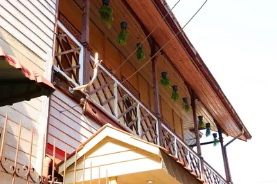 a person on a balcony of a building with plants at Baankhon Private room in Thai house Check in by yourself code inbox Adult Only in Bangkok