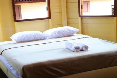 a bed with two pillows and a towel on it at Baankhon Private room in Thai house Check in by yourself code inbox Adult Only in Bangkok