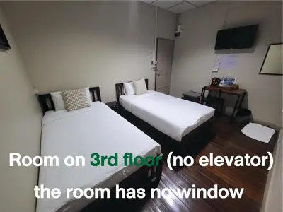 a room with two beds with a room on floor at Achcha hotel - itsaraphap MRT station - Wat Arun in Bangkok
