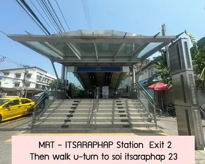 a stairwayexit to a subway station with a yellow taxi at Achcha hotel - itsaraphap MRT station - Wat Arun in Bangkok