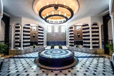 a lobby with a large fountain and a large chandelier at The Siam in Bangkok