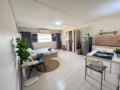 a living room with a couch and a table at Condo Popular T4 Impact Muangthong by Tide in Pak Kret