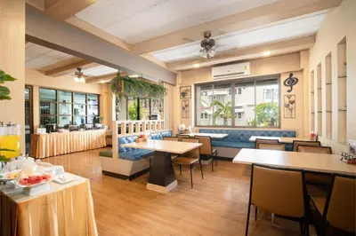 a restaurant with tables and chairs in a room at P-Park Hotel Bangkok in Bangkok