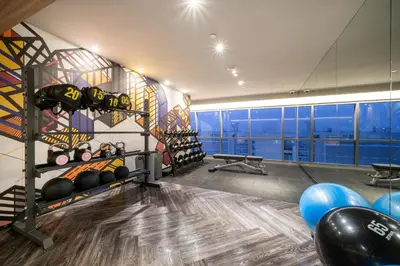 a room with a gym with lots of equipment at Triple Y Hotel in Bangkok