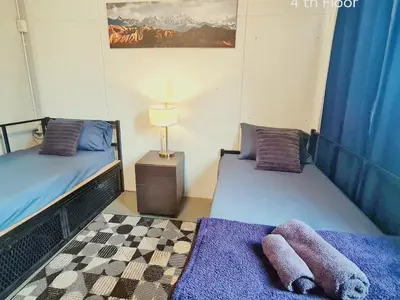 a room with two beds and a lamp in it at MEEMAW'S House Hostel in Bangkok