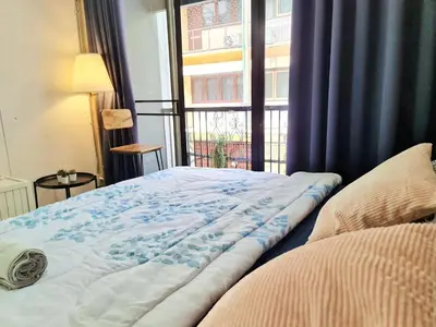 a bed sitting in a room with a window at MEEMAW'S House Hostel in Bangkok