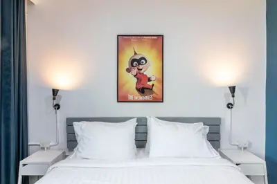 a bedroom with a bed with a poster on the wall at Every Surawong in Bangkok