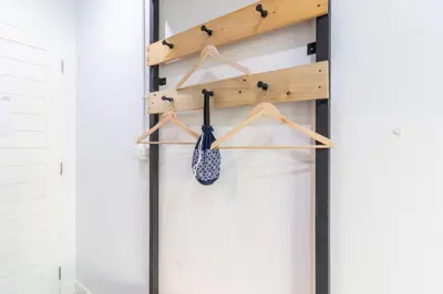 a closet with a wooden shelf with a tennis racket at Every Surawong in Bangkok