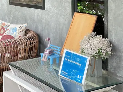 a glass table with a figurine on top of it at The Quarter Wutthakat in Bang Khun Thian