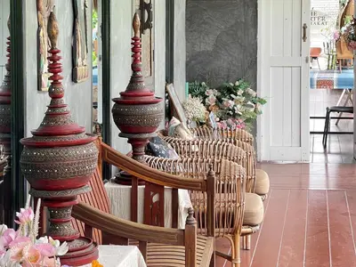 a room with a group of chairs and poles at The Quarter Wutthakat in Bang Khun Thian