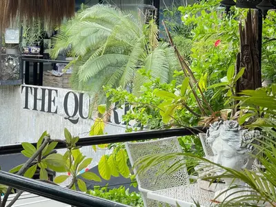 a shop with plants and a sign that says the ox at The Quarter Wutthakat in Bang Khun Thian
