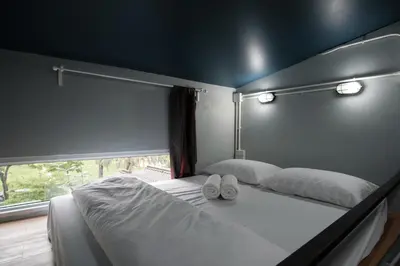 a bedroom with two white shoes on a bed at Private Stay Hostel in Bangkok