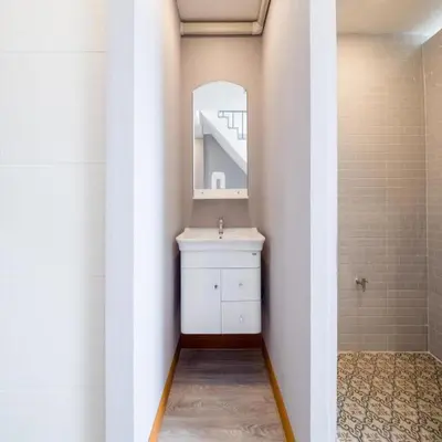 a bathroom with a sink and a mirror at Bossa House Hostel & Cafe in Bangkok