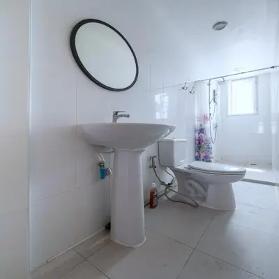 a bathroom with a sink and a mirror on the wall at Bossa House Hostel & Cafe in Bangkok